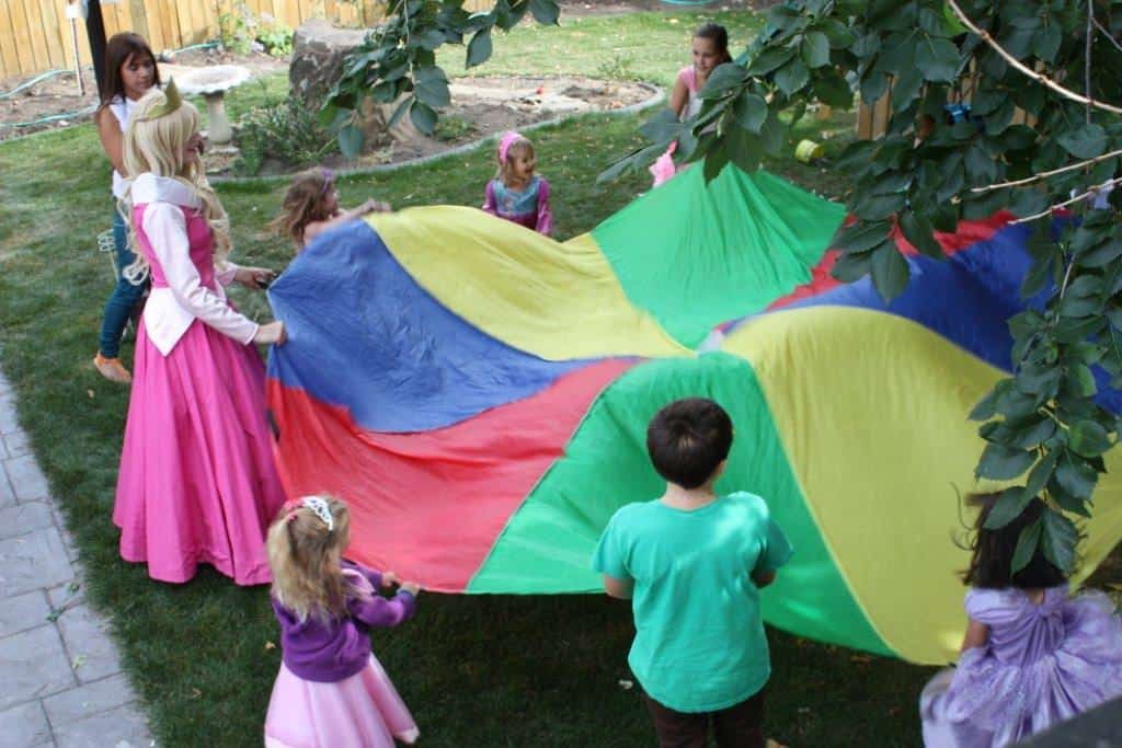 Princess Cinderella and Princess Sleeping Beauty Playing parachute games at a Calgary princess birthday party in Calgary Princess Cinderella and Princess Sleeping Beauty Playing parachute games at a Calgary princess birthday party in Calgary