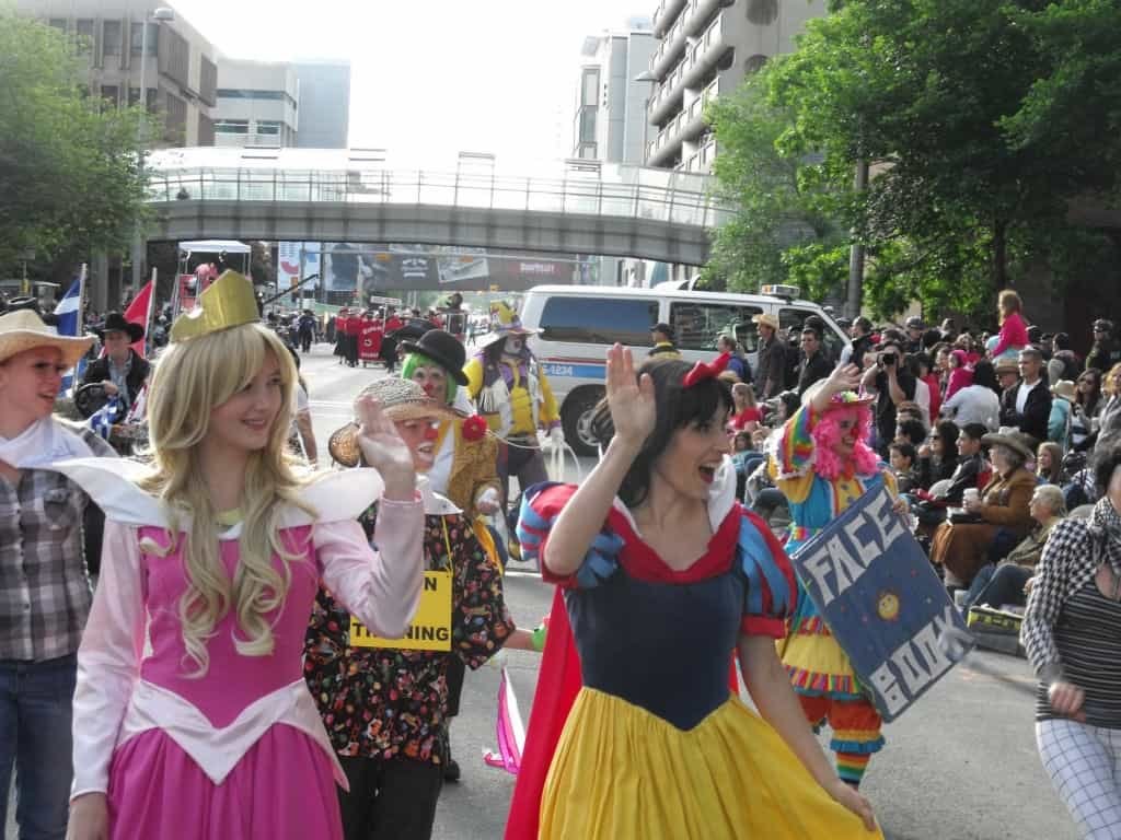 Princess Sleeping Beauty and Princess Snow White posing with fan at Calgary Stampede Parade 2012