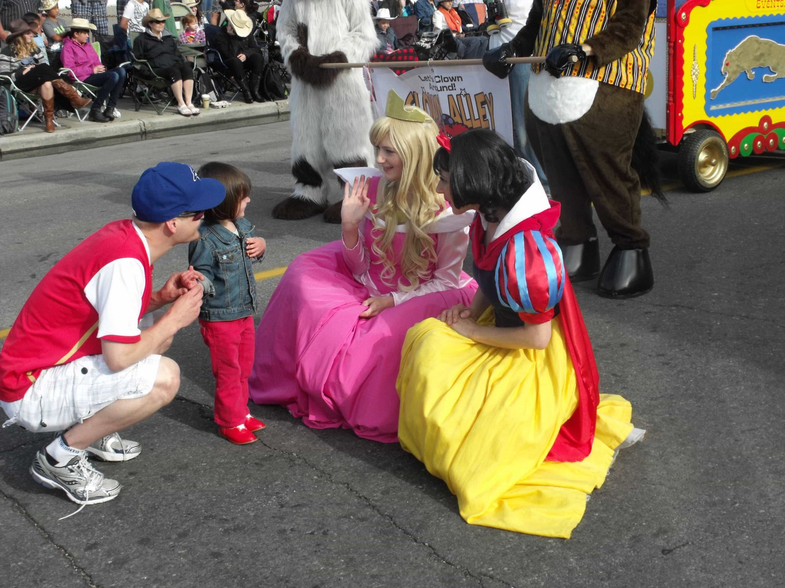 Princess Sleeping Beauty and Princess Snow White posing with fan at Calgary Stampede Parade 2012