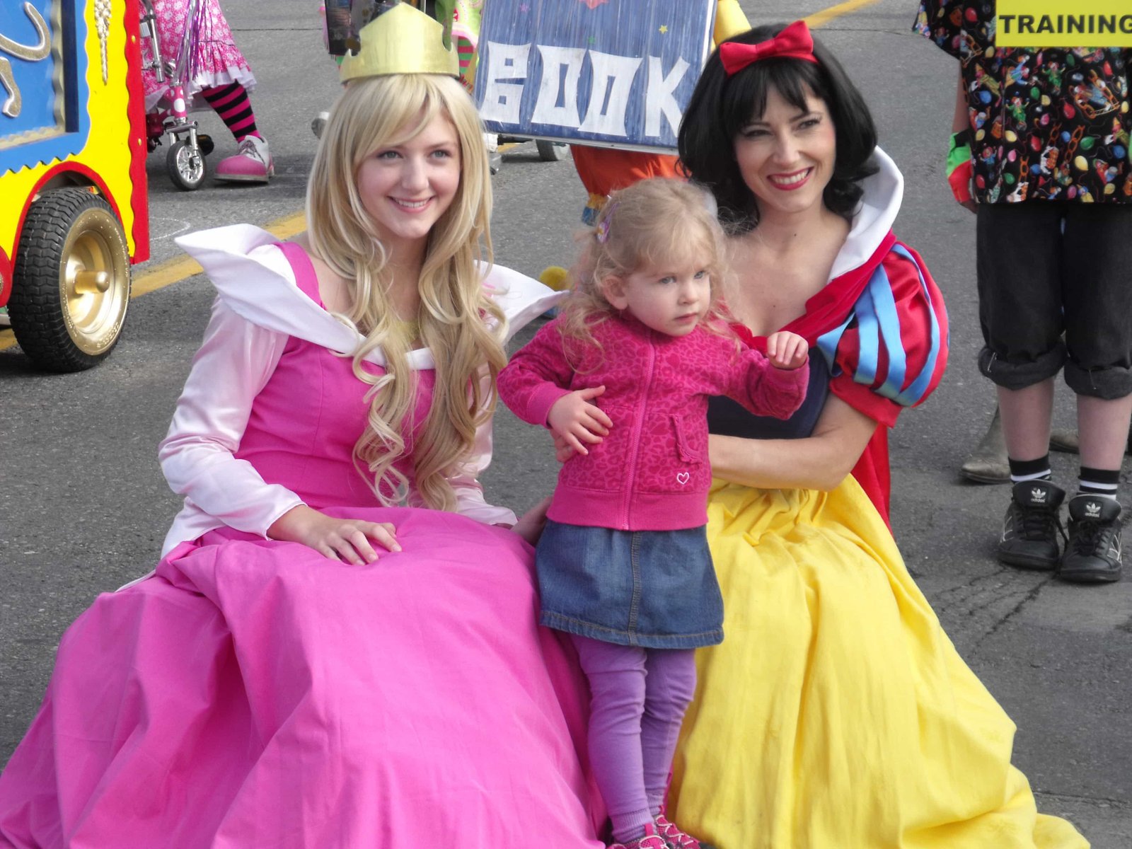 Princess Sleeping Beauty and Princess Snow White posing with fan at Calgary Stampede Parade 2012