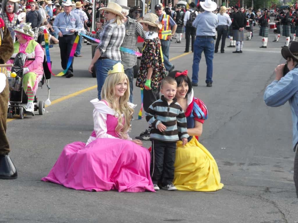 Princess Sleeping Beauty and Princess Snow White posing with fan at Calgary Stampede Parade 2012