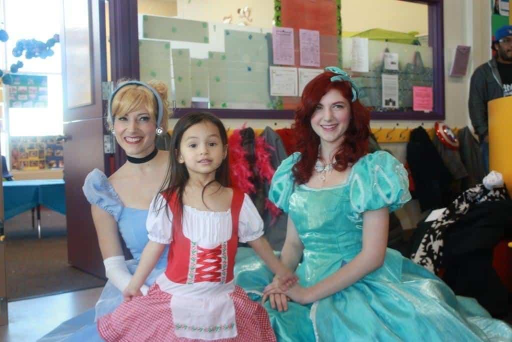 Princess Cinderella and Princess Little Mermaid posing with birthday girl