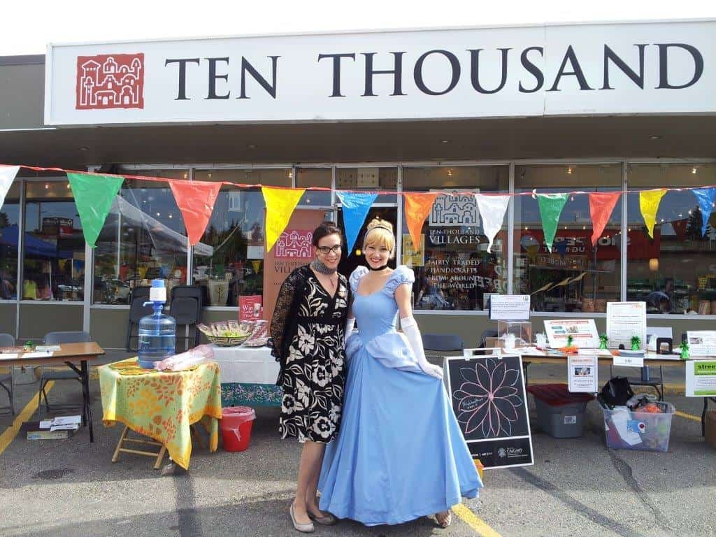 Princess Cinderella with the fair trade food display outside Ten Thousand Villages Calgary