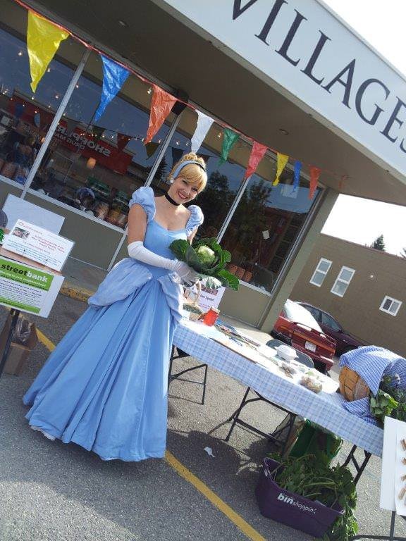 Princess Cinderella holding produce from the Community Garden