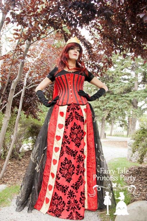 The Queen of Hearts looks at the subjects around her and wishes she could get rid of Alice in Wonderland and the Mad Hatter's silly antics.