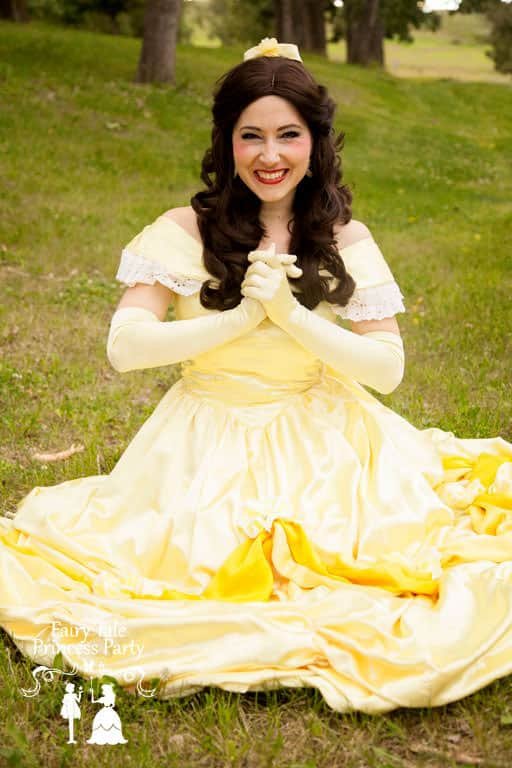 Beauty Princess sitting in Calgary Grass in her pale yellow dress