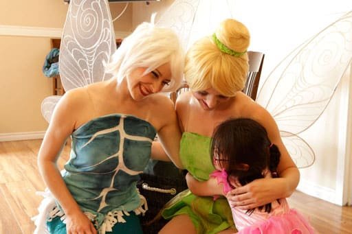 The Frost Fairy and Forest Fairy receive an enthusiastic hug from the birthday girl