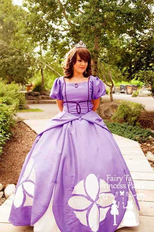 The Purple Princess in her best ballroom gown for birthday parties waits on a Calgary boardwalk.